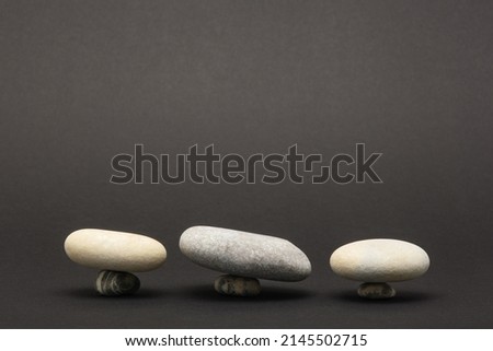 gray stones podiums or platform on black background for presentation of various products, concept, copy space