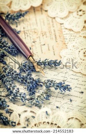 vintage ink pen, dried lavender flowers and old love letters. retro style toned picture