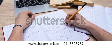 the student solves math problems. Calculating the derivative. Learning advanced mathematics in college Royalty-Free Stock Photo #2145525959