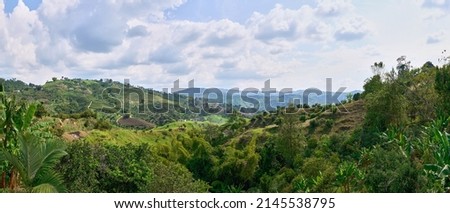Panoramic view of landscape from a high mountain against a beautiful background of a coffee and bamboo farm with its country house. Colombian Coffee Axis Royalty-Free Stock Photo #2145538795
