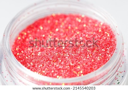 colored sequins in a plastic jar close-up. High quality photo