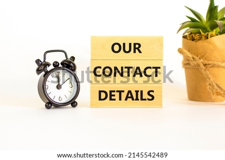Our contact details symbol. Concept words Our contact details on wooden blocks. Beautiful white background. Black alarm clock. Business our contact details concept. Copy space.