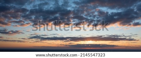 Natural abstract background. Morning dawn sky, clouds illuminated by the scorching morning sun.