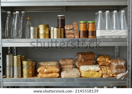 Background image of shelves stacked with food donations at help center for refugees and people in need, copy space