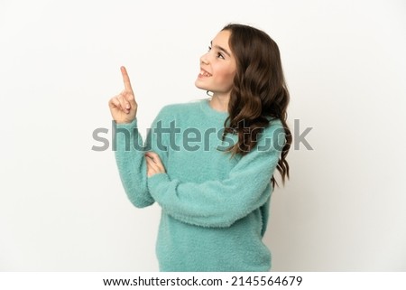 Little caucasian girl isolated on white background pointing up a great idea