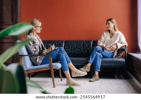 The psychotherapist interviews and consults the patient during the session. Royalty-Free Stock Photo #2145564917