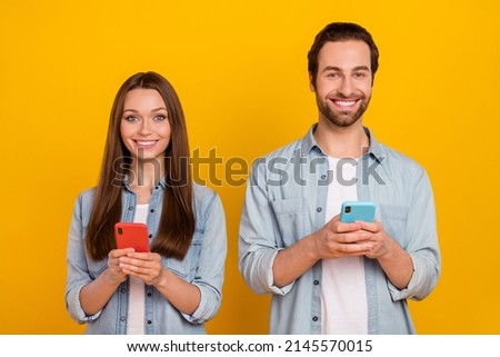 Photo of cute young brown hairdo couple with telephone wear jeans shirt isolated on yellow background