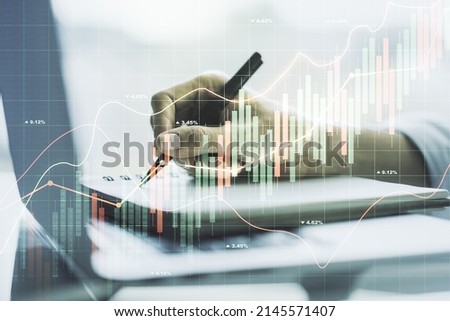 Abstract creative financial graph with hand writing in notebook on background, forex and investment concept. Multiexposure