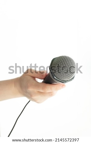 microphone for an interview, the hand of a press journalist holds a speaker,isolated on white