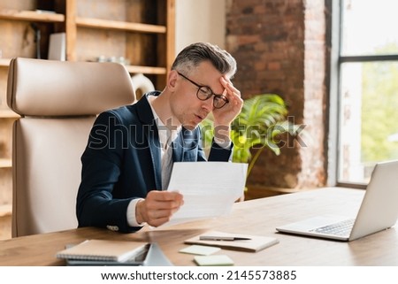 Overload in office. Business problems, debt, credit loan bankruptcy. Caucasian mature middle-aged businessman freelancer ceo boss lawyer receive sad news, bills, fired, mortgage divorce issues Royalty-Free Stock Photo #2145573885