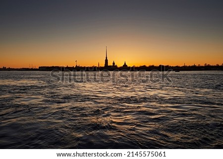 Peter and Paul Fortress on the Neva River against the sunset sky. Silhouette of the sights building