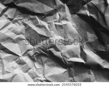 Dense, heavily crumpled paper forms a relief background with pronounced folds and irregularities. Royalty-Free Stock Photo #2145576033