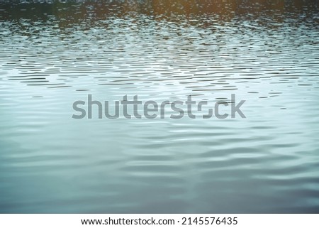 Ribbed water surface outdoors on cloudy day, low angle view.