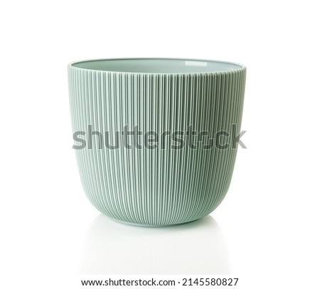 Empty flower pot isolated on a white background. Decorative plant pot cutout. Greenish gray plastic container for growing indoor plants. Vertical striped planter for interior design. Front view. Royalty-Free Stock Photo #2145580827