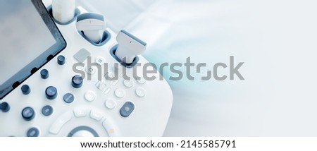 Modern medical equipment. An ultrasound machine and a couch. web banner Royalty-Free Stock Photo #2145585791