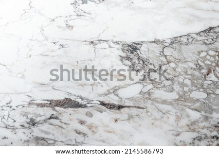 White marble stone texture top view. abstract pattern with grey and brown streaks for background or design art