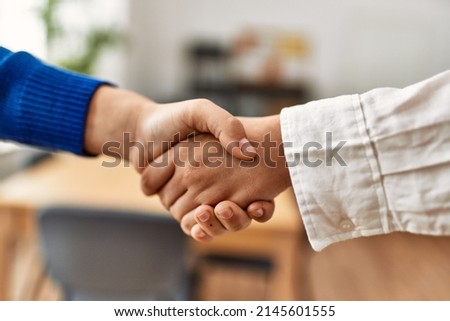 Women hands signing contract with handshake at the office.