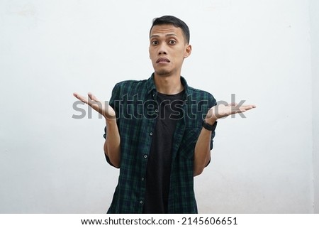 Portrait of asian man wearing casual clothes confused shrugging, asking and not knowing what happened. white background Royalty-Free Stock Photo #2145606651