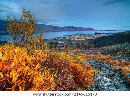 Beautiful autumn arctic landscape. Evening view of the port town on the coast of the bay. Travel to the extreme North of Russia. Egvekinot, Chukotka, Russian Far East. Kresta Gulf, Bering sea. Royalty-Free Stock Photo #2145615173