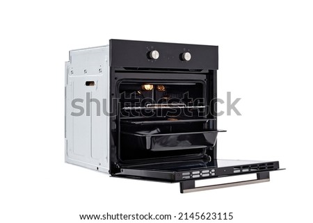 Black oven with open door and three trays, with two control knobs. at an angle of 45 degrees. Isolate on white