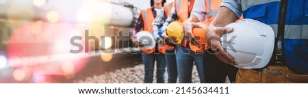 Team engineer holding helmet standing in row on site work, banner cover design. Royalty-Free Stock Photo #2145634411