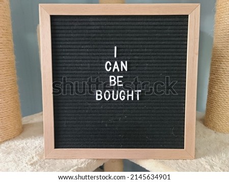 A sign saying I can be bought. The felt sign has removable letters than can be moved around to make whatever words or saying one wants. 