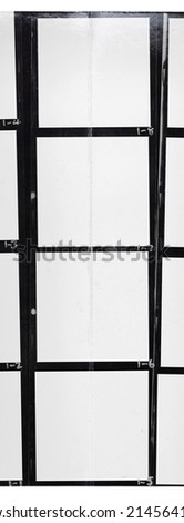 photo of black and white medium format hand copy contact sheet with empty frames and interesting torn paper surface. retro photo placeholder with folding mark.
