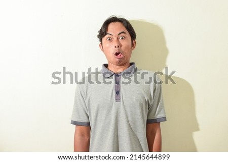 asian male facial expressions , shocked, wow, kidding, slapped, beaten or punched. Indonesian man portrait on white background isolated Royalty-Free Stock Photo #2145644899
