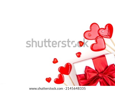 Gift with a bow and candy hearts on a white background. Congratulations, space for text.