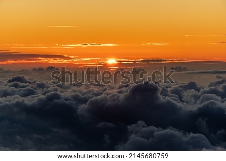 Sunset over clouds at Haleakala National Park in Maui, Hawaii