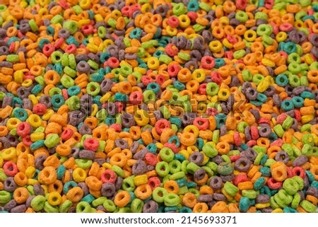 Sweet multicolored flakes, cereal loops as a background.. 
