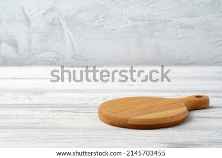 Wooden board for food on wooden background, close up