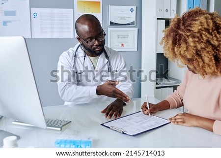 Woman signing medical agreement at hospital