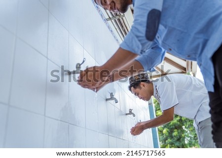 Man muslim perform ablution or wudu at the mosque Royalty-Free Stock Photo #2145717565