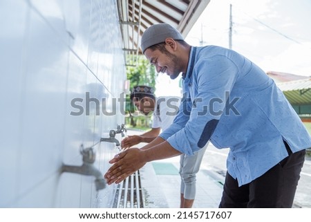 Man muslim perform ablution or wudu at the mosque Royalty-Free Stock Photo #2145717607