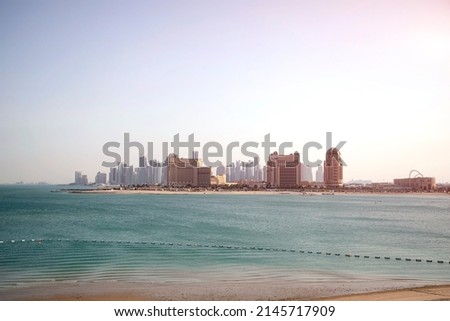 A panoramic view across Katara Beach, West Bay, Qatar, towards the Doha skyline, during sunset
