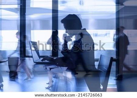 Double exposure concept of businessman focused working at office desk in a busy city environment. Fast pace work rush.  Royalty-Free Stock Photo #2145726063
