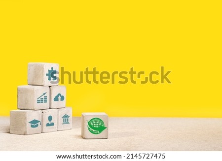 Concrete cubes, blocks on a yellow background. Business strategy and action plan concept. With copy space