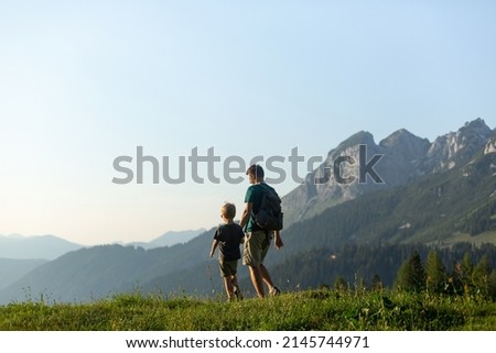 Family time concept. Father and son hiking in the Austrian Alps Royalty-Free Stock Photo #2145744971