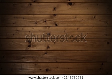 Dark wooden boards background. Planks of pine tree with knots.