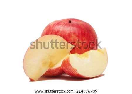 Photo of a ripe real red apple on a light yellow background, cut a piece of apple