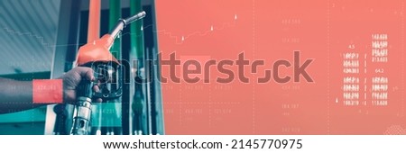 Gas station with fuel dispensers on technological background. Graph of rising prices for gasoline and fuel Royalty-Free Stock Photo #2145770975