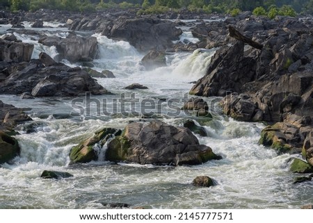  A Rocky River waterfall flowing on a summer day Royalty-Free Stock Photo #2145777571