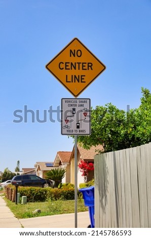 No Center Line and Vehicles Share Center Lane, Yield to Bikes signs. Two way shared single lane. Royalty-Free Stock Photo #2145786593