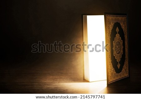 Open holy book on dark background