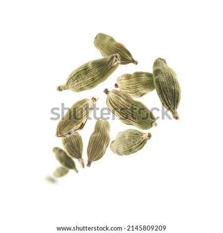 Cardamom pods levitate on a white background Royalty-Free Stock Photo #2145809209