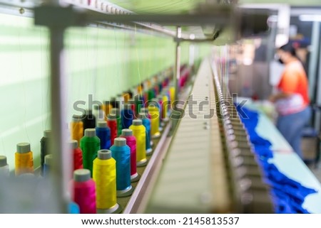 Multicolor sewing threads on industrial embroidery machine. select focus of Multicolor sewing threads. tailor sewing concept.