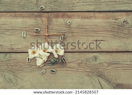 Easter composition of a wooden cross and flowers