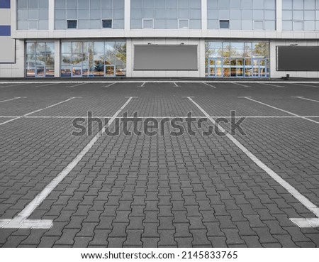 Empty parking lot near supermarket Royalty-Free Stock Photo #2145833765