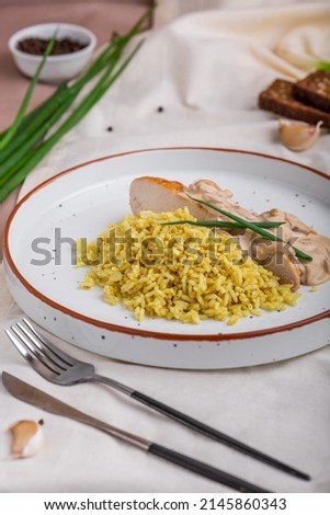 Halibut fillet with bulgur and creamy lemon sauce. Cooked fish fillet with garnish in ceramic dishware. Modern food in a minimalist style. Beautiful serving of the dish.